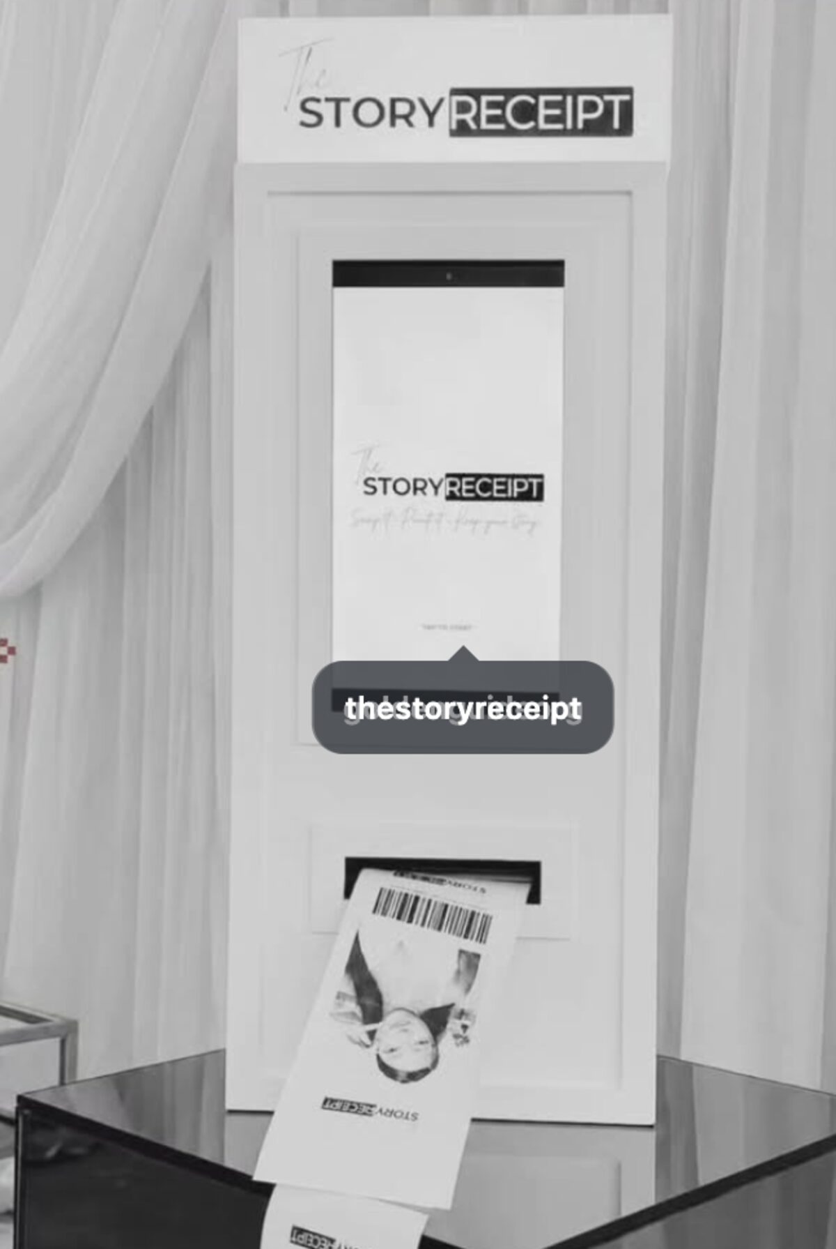 A receipt photo booth printing a guest's photo on a keepsake receipt
