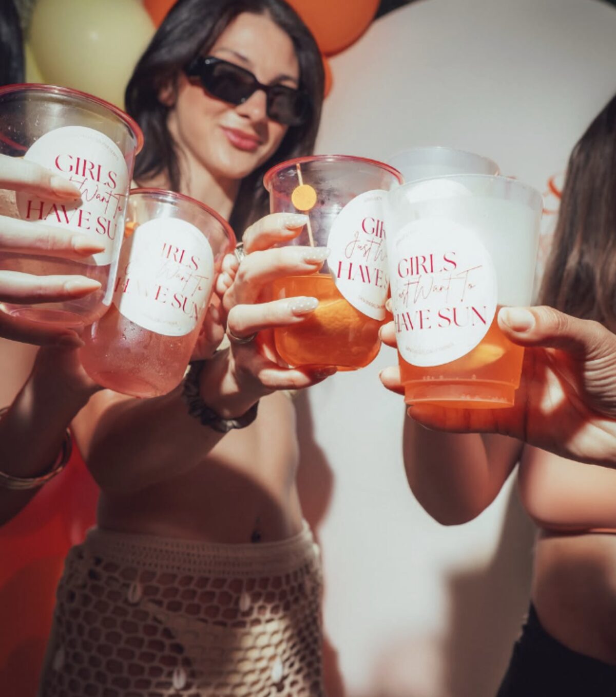 Friends toasting with custom Girls Just Want to Have Sun cups